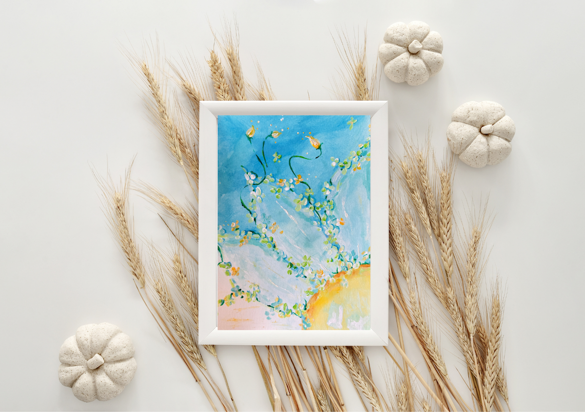 Framed artwork of a beach scene with seashells and pumpkins on a light background.