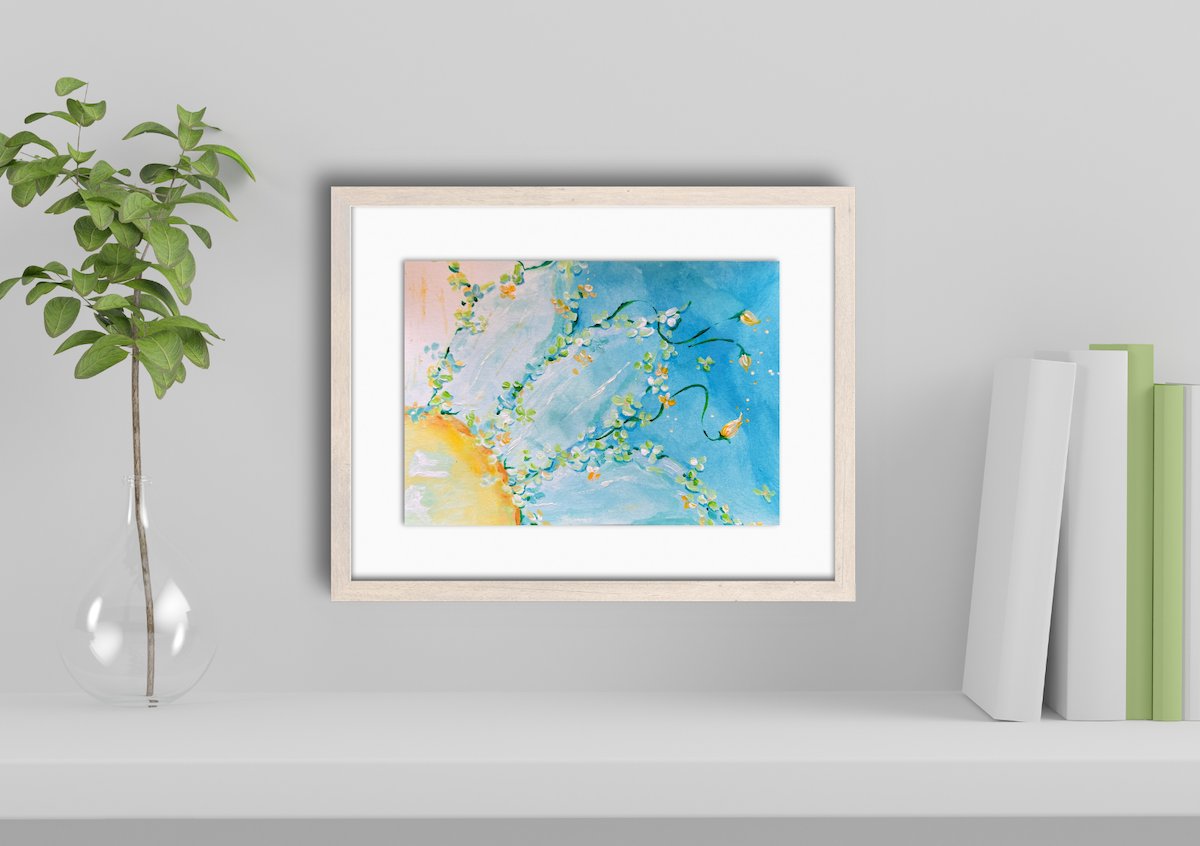 Framed abstract art on a gray wall with a plant and books.