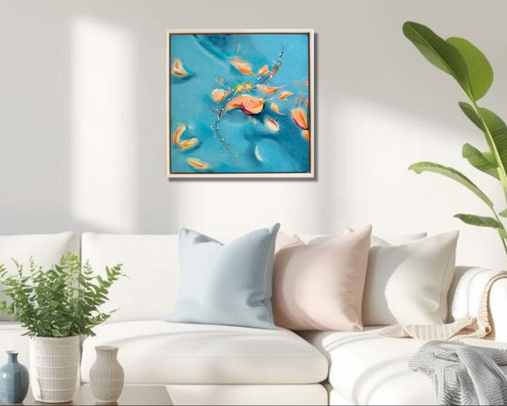 Living room with a white sofa, decorative pillows, and a abstract artwork in a floating frame on the wall.