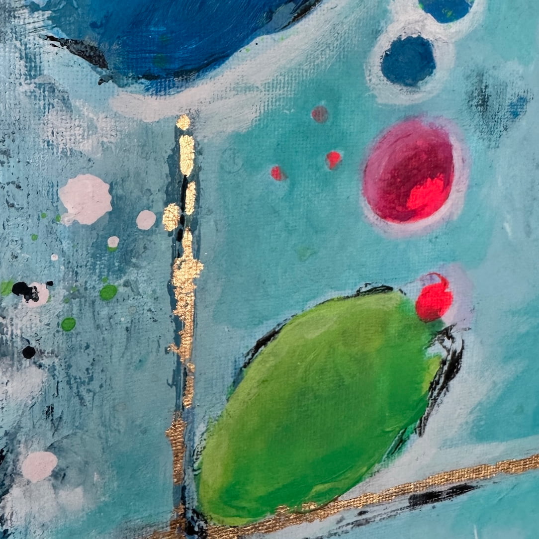 Close-up of abstract artwork with green, red, and blue colours on a textured surface