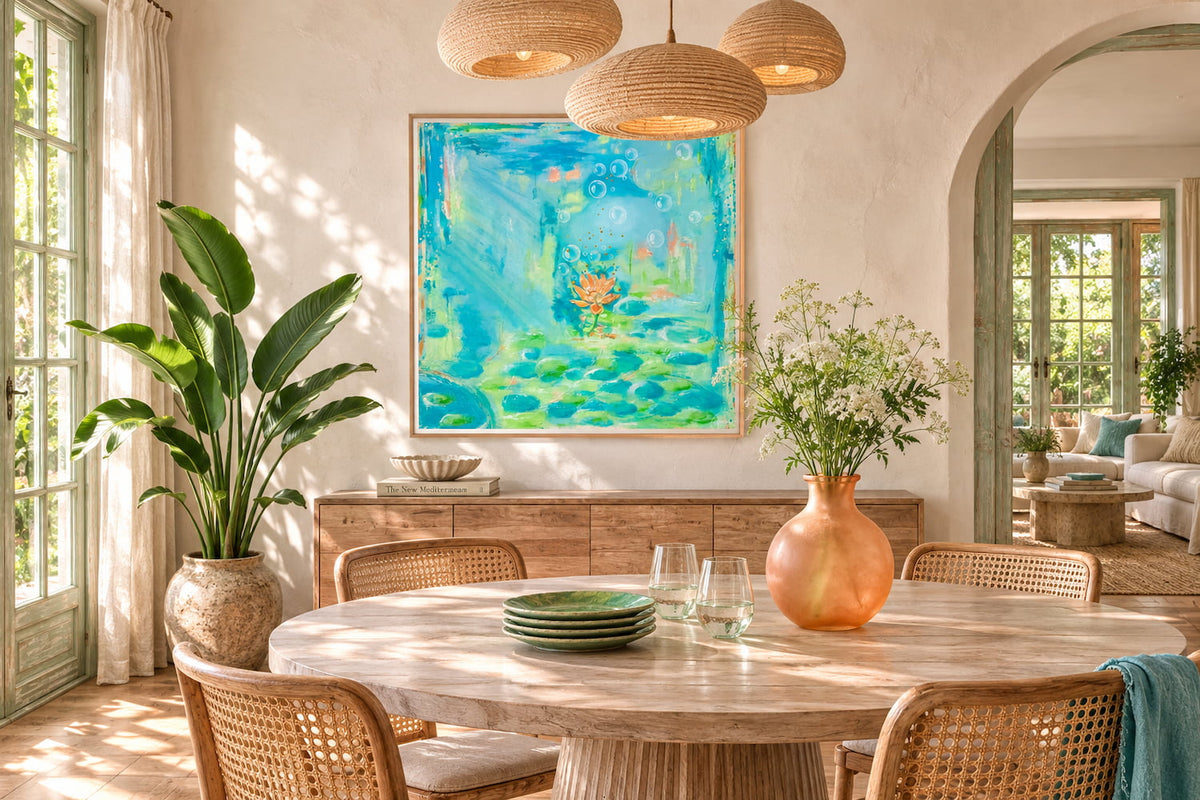 A luminous blue and green abstract wall art hangs on a beige wall in a beautifully styled dining room with a wooden dining table, woven chairs, and a terracotta vase.