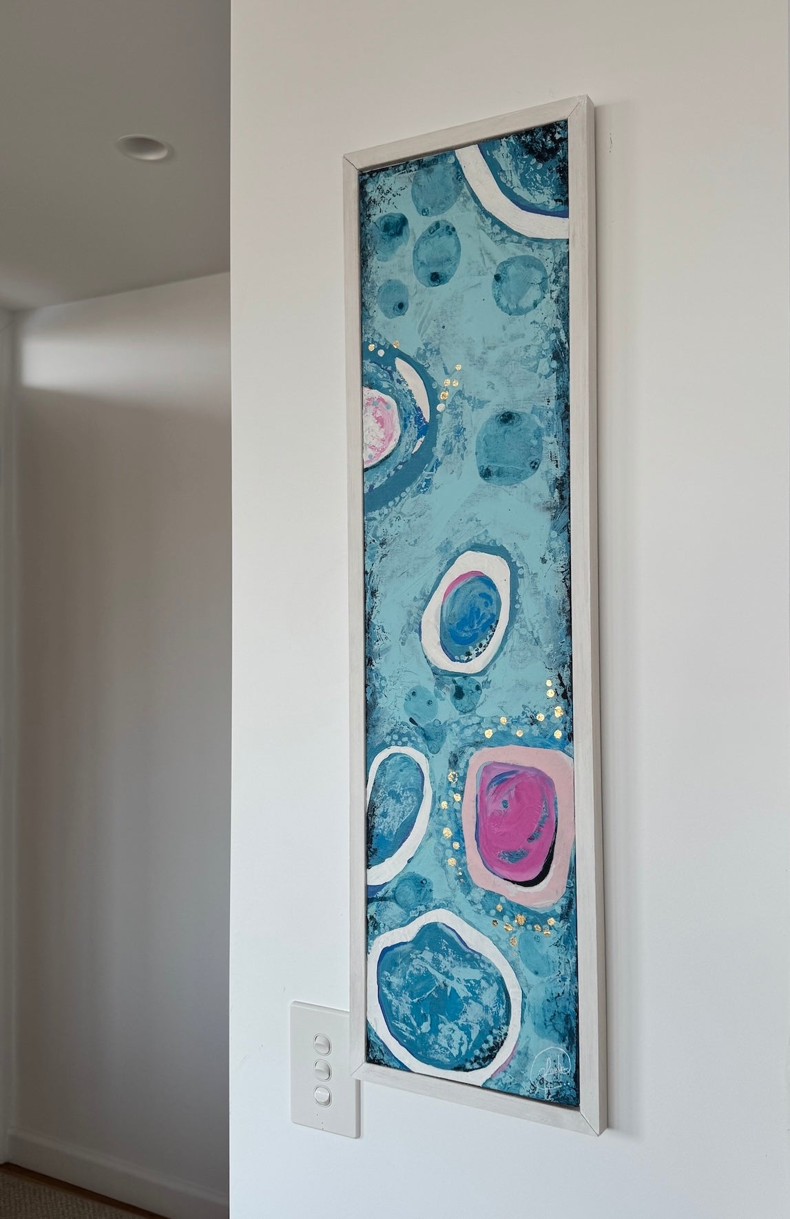 Dare to be Different joyful large original wall art white framed on a white wall in a hallway.
