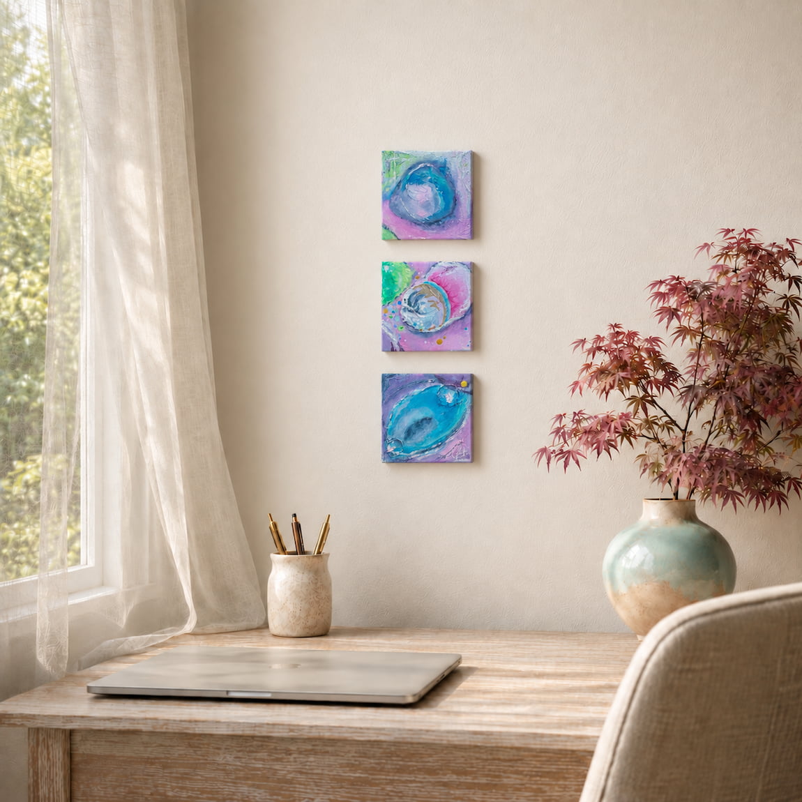 Textured blue and pink artwork set displayed above a home office desk