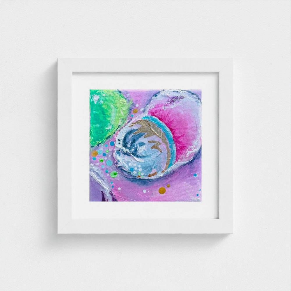 Enchanting Energy 2 in a white frame with pink, green and gold