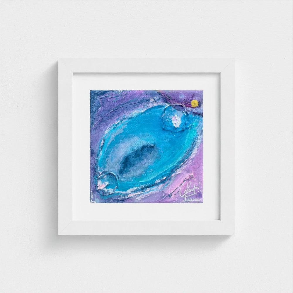 Enchanting Energy 3 fine art print in a white wood frame on a plain wall, turquoise and violet abstract painting with a small gold accent.