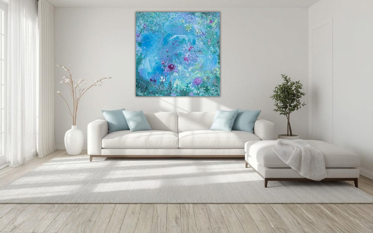 Modern living room with a white sofa, decorative pillows, and a large abstract painting on the wall.