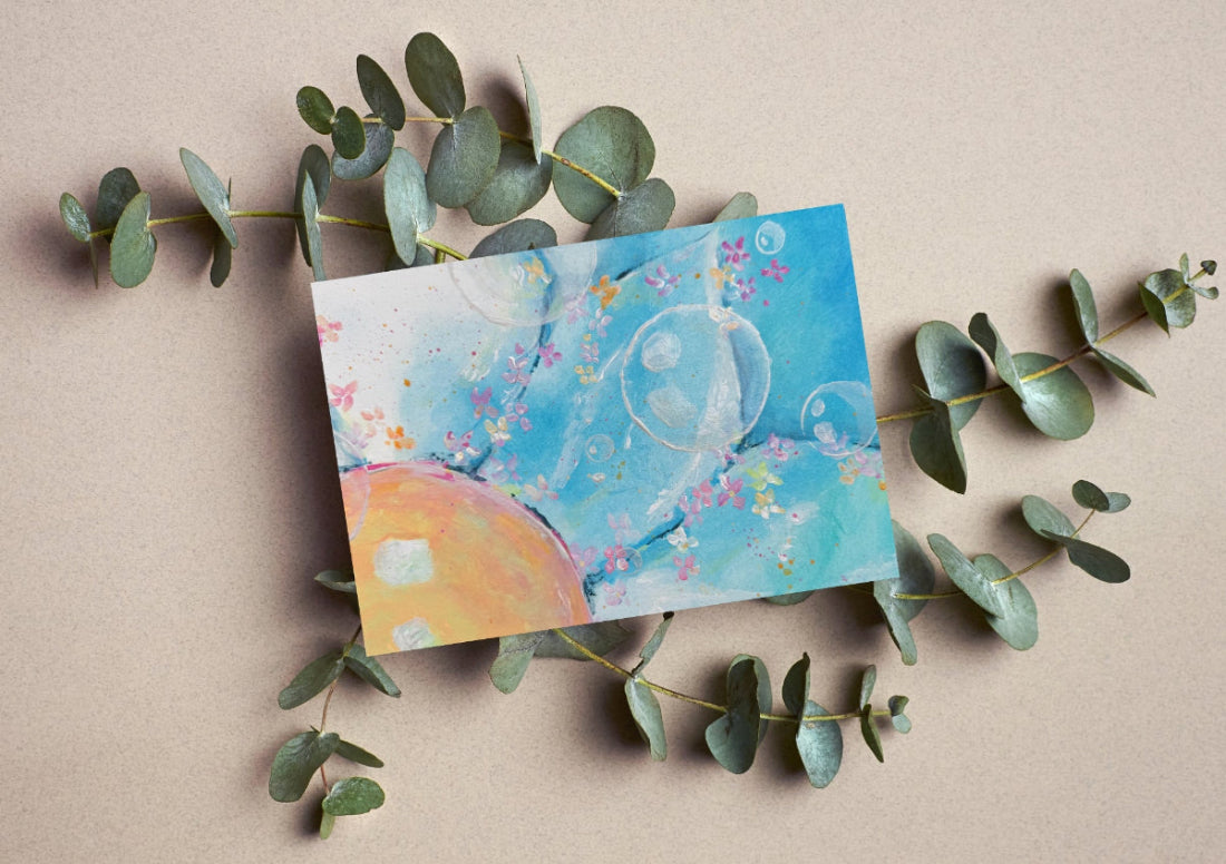 Colorful card with abstract design on a beige background with eucalyptus leaves