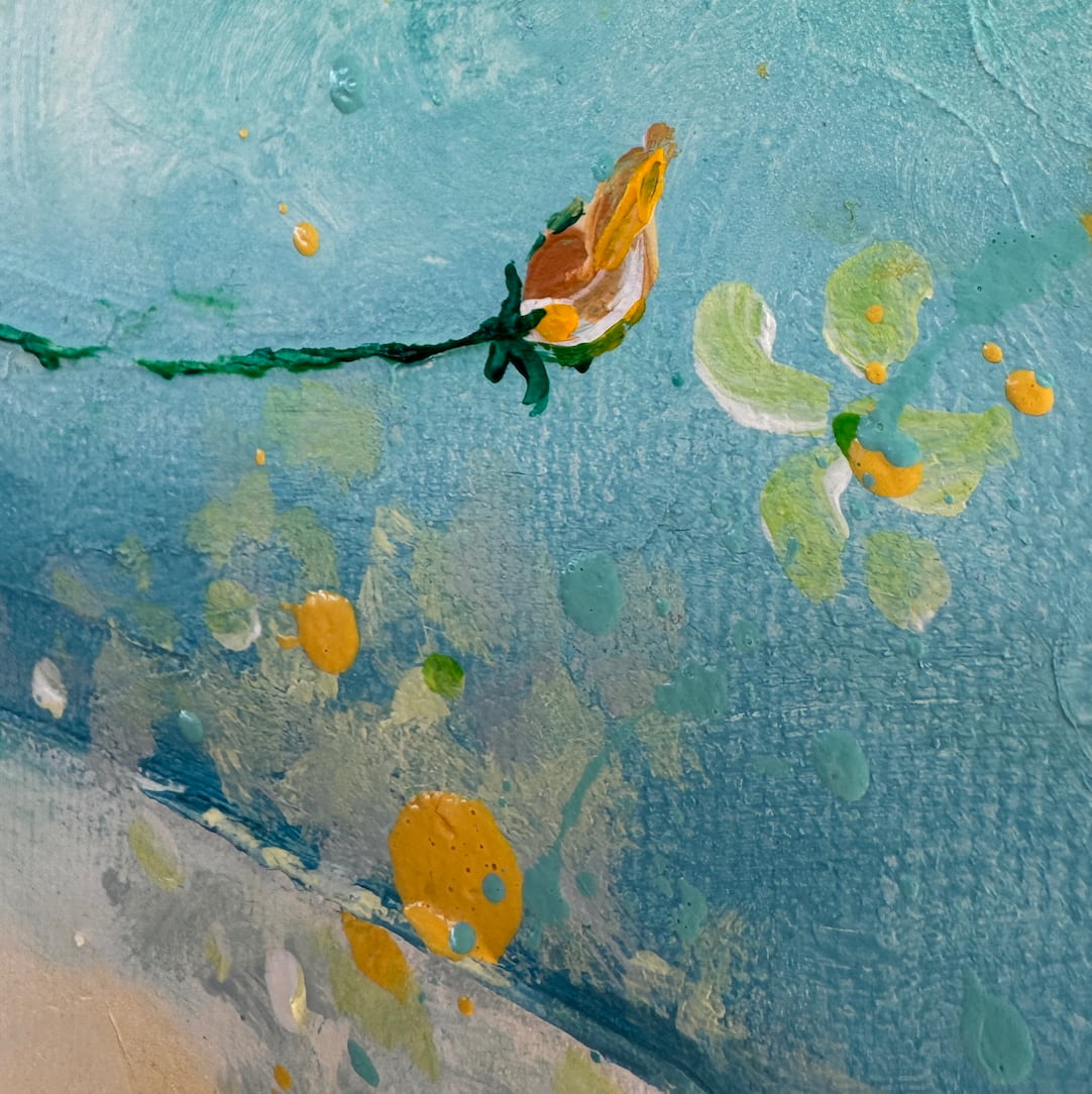 Abstract floral painting detail with a single bud in orange and green on a textured light blue background.