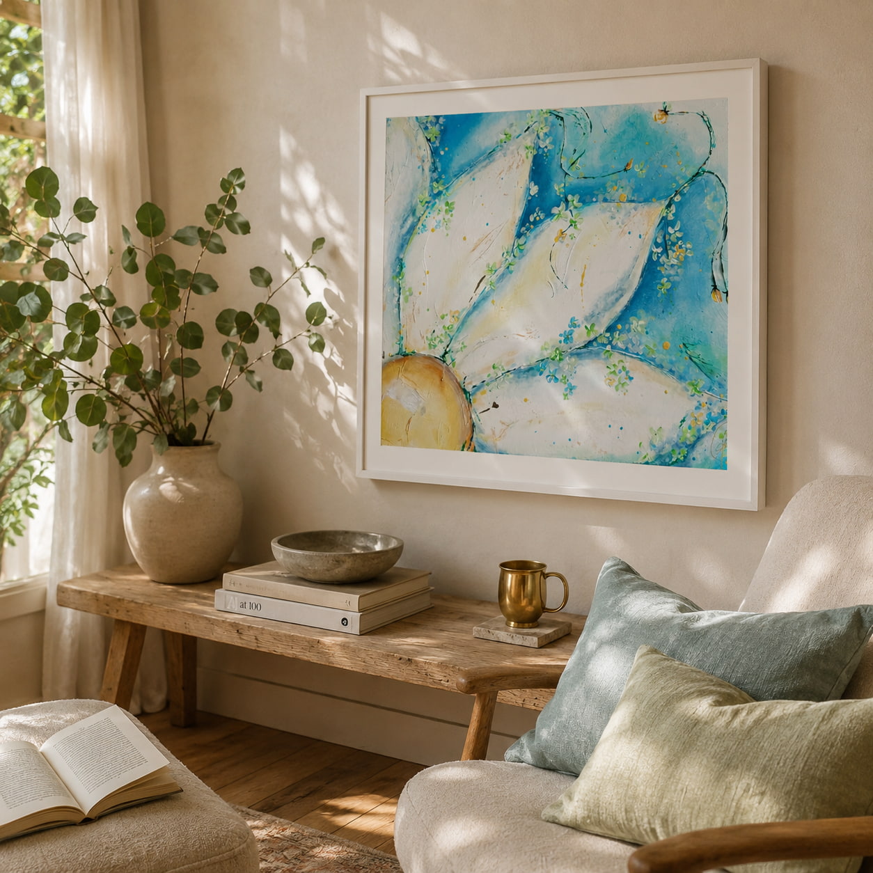 Framed abstract art prints with flowers on a wall in a cozy reading corner