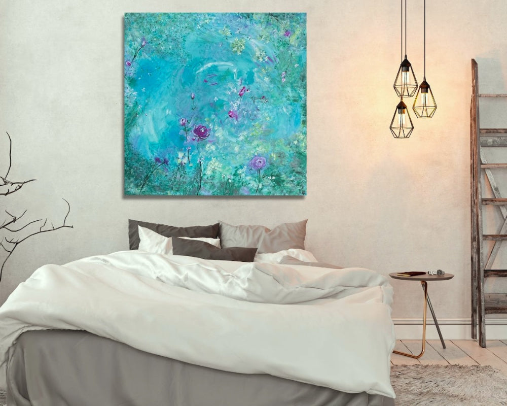 Large abstract wall art with flowers above a bed in a soft bedroom setting 