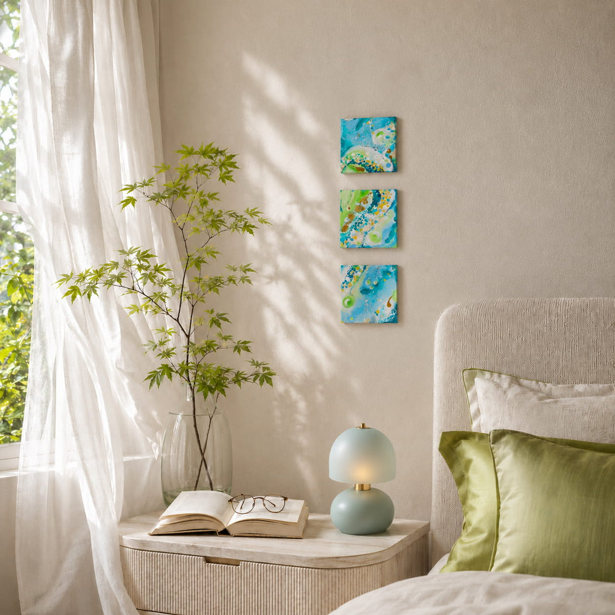 Why Not 3-piece wall art set above bedroom nightstand small square blue and green abstract canvas paintings in a soft sunlit bedroom