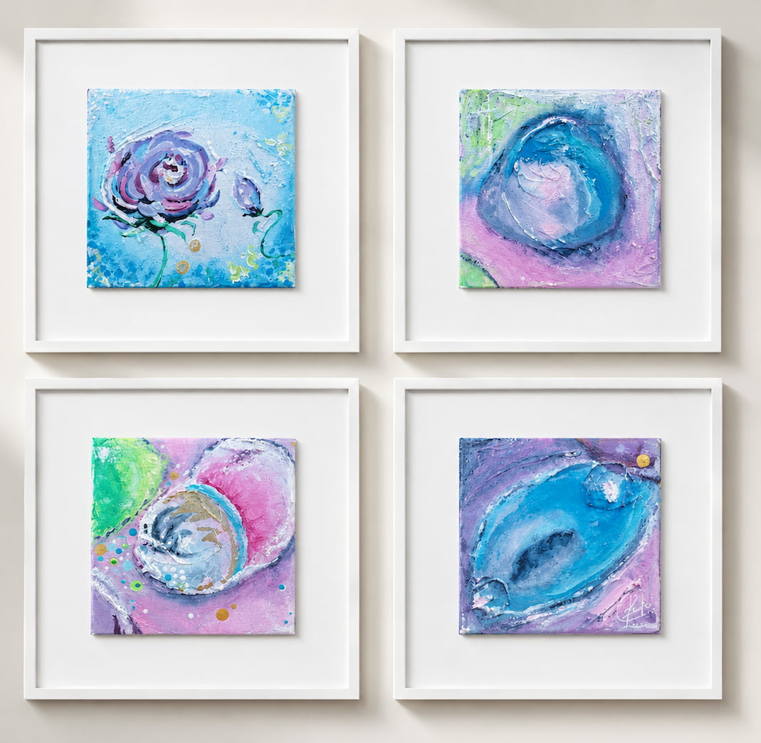Four framed abstract wall art prints arranged in a 2x2 grid on a light beige wall with organic floral and oval forms in blue, purple, pink, and green.