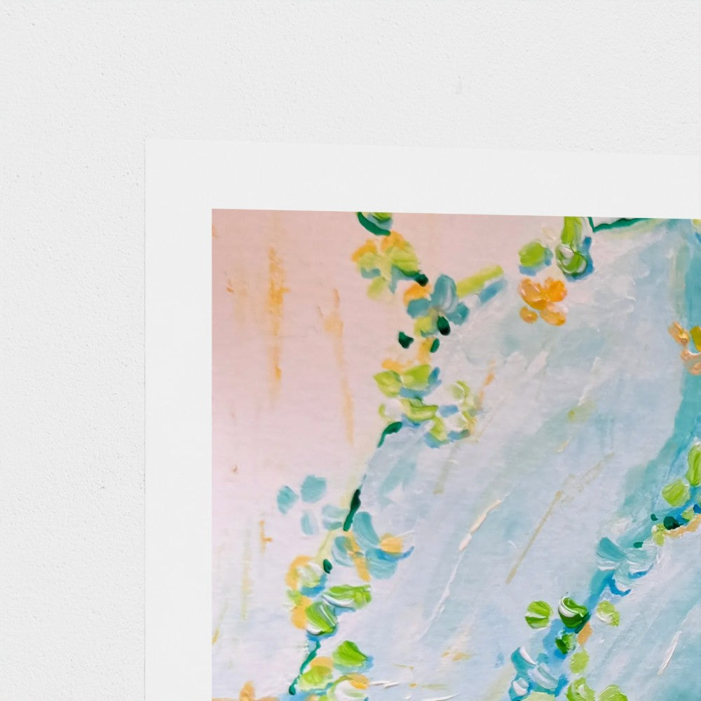 A close-up of an abstract art print in light blue, soft pink, green, and yellow, bordered by a wide white margin.
