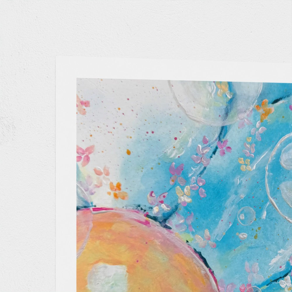 Close-up of a colorful abstract art print with flowers on a white background